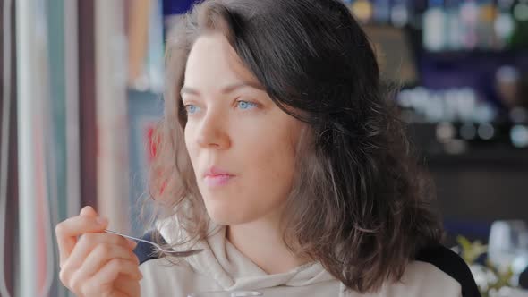 Beautiful Blue Eyed Woman Eatting Hot Chocolate at Cafe