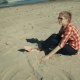 Girl Sitting On the Beach - VideoHive Item for Sale