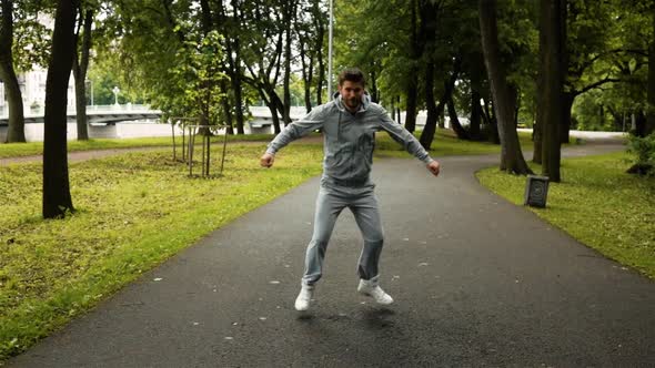 Man Exercising and Dancing on Asphalt in Park