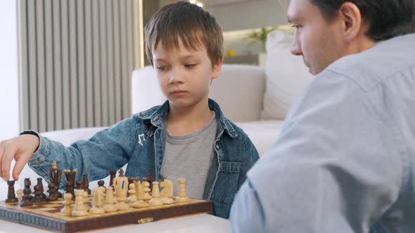 Father and Son Playing Chess