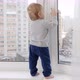 Baby boy standing on windowsill and pulling window handle - VideoHive Item for Sale