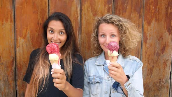 Girls Looking At Camera With Ice Cream In Hands