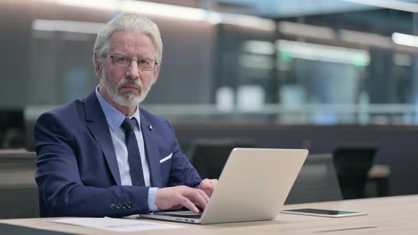 No Gesture with Finger By Old Businessman at Work