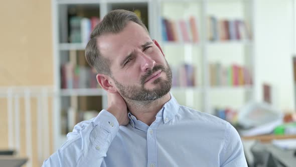 Portrait of Exhausted Young Man with Neck Pain