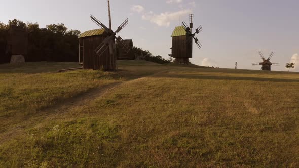 Idle Wooden Mills on the Countryside Field