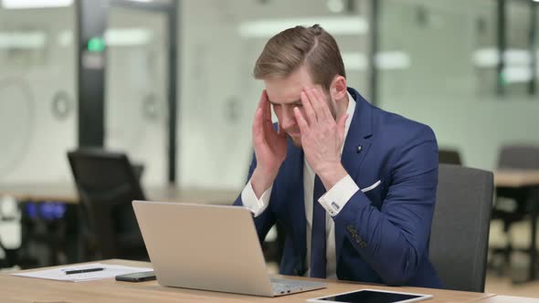 Young Businessman Having Headache While Working on Laptop