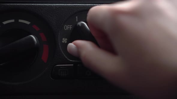 The Woman Turns on the Fan and Presses the Air Conditioner Button in the Car