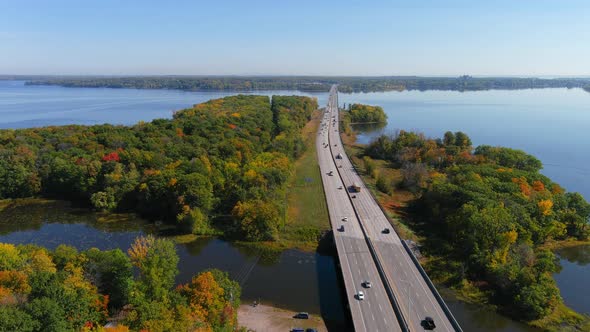 Traffic flowing smoothly on Canadian motorway, fall season colors.