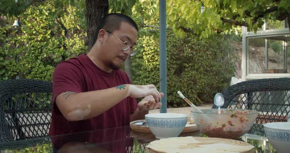 Chinese Men Making Asian Food Wonton with Bough and Minced Meat Outdoors