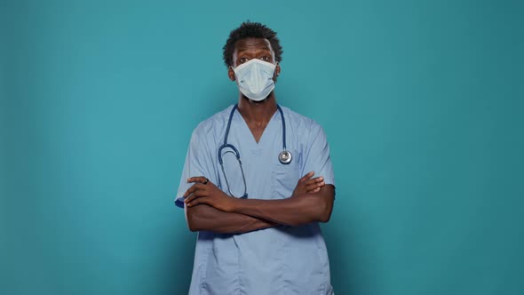 Man Nurse Standing with Crossed Arms While Wearing Face Mask