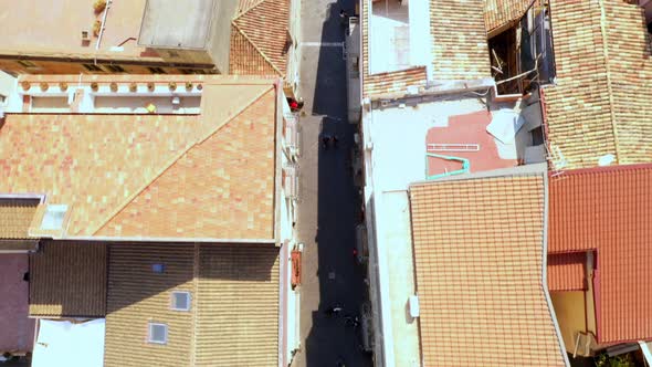 Vertical shot flying across a long walkway during a sunny day. Near the downtown of Taormina, Sicily