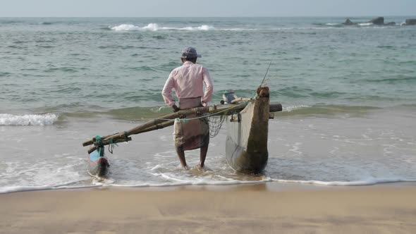 Local Fisherman Pulls Hand Made Fishing Construction By Sea