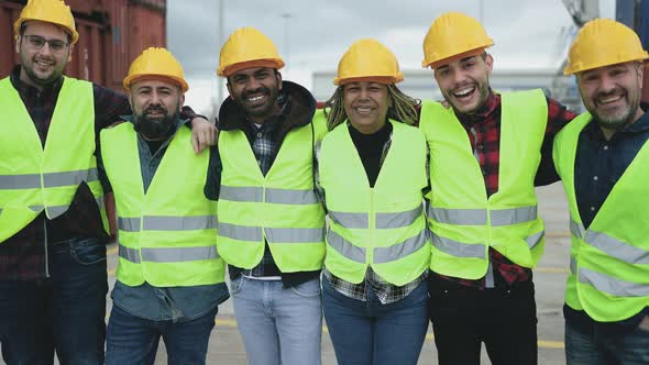 Team of diverse industrial engineers working in logistic terminal of container cargo