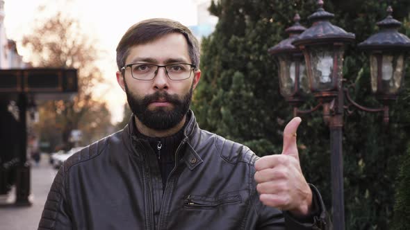 Portrait of Young Attractive Bearded Man in Glasses and Looking at the Camera