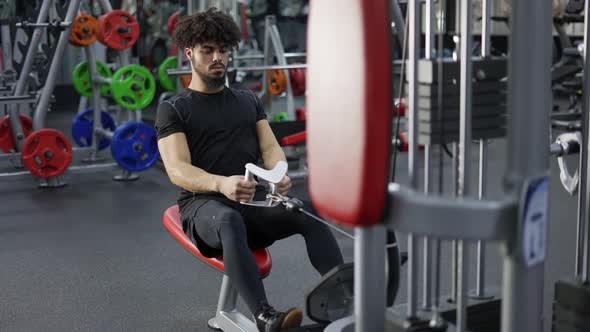 Intensive Workout in Gym Man Doing Cable Row Exercise Slow Motion