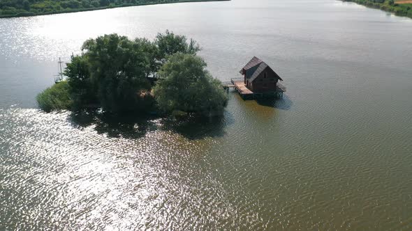 Small island and a house in the middle of the river.