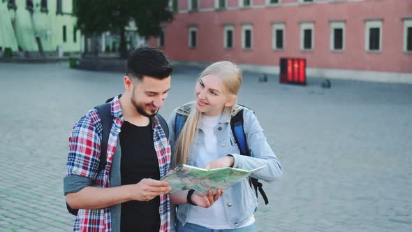 Man and Woman Tourists with Map Looking for New Historical Place in City Center