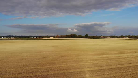 Aerial view of golden fields with brown mold close to Sejerøbugten in Odsherred.