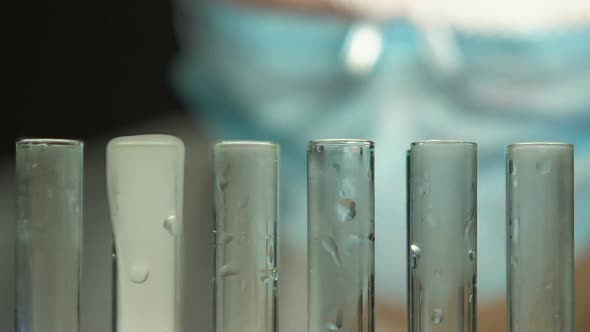 Chemical Worker Adding Liquid Into Test Tubes, Monitoring Boiling Reaction