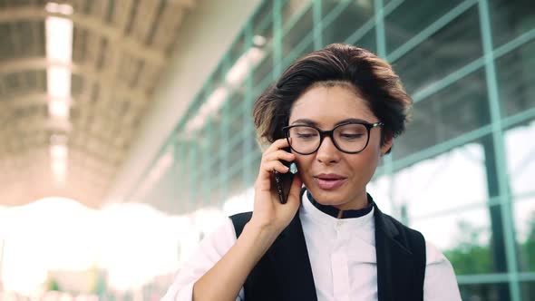 Young Beautiful Businesswoman Speaking on Phone Smiling Business Centre Background