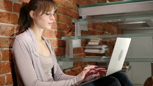 Pensive Thinking Woman Working on Laptop Sitting on Stairs