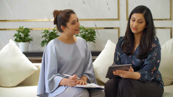 Two Asian Women Talking