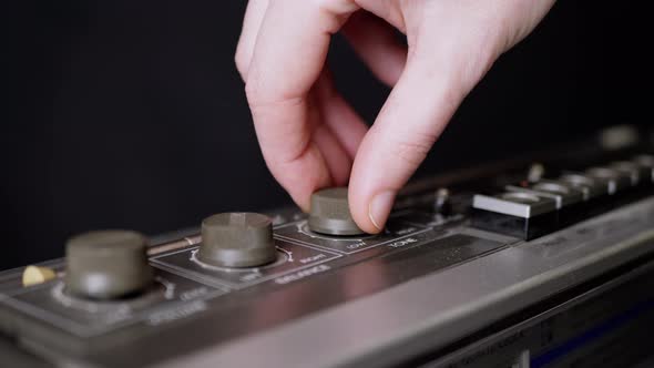 Female Fingers Spinning the Volume Balance Knobs on an Old Tape Recorder