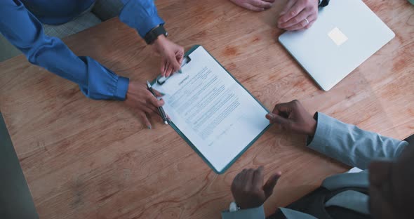 Close up of a busineswoman handing over a contract to a businessman