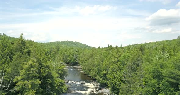 Rising high above a river and the forest at Tobey Falls near Willimantic, Maine.