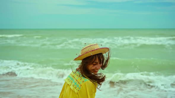 Portrait Happy Expression Woman with Blowing Hair Wearing Yellow Shirt Having Fun on Beach and