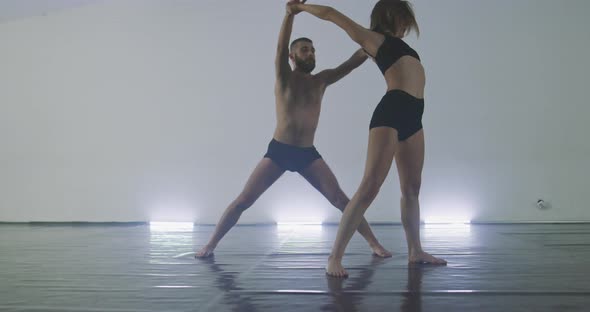 Couple Preforming Art or Contemporary Dance in Room Filled with Smoke