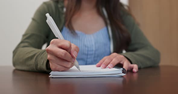 Woman write on note book at home