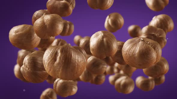 Flying of Hazelnuts in Purple Background