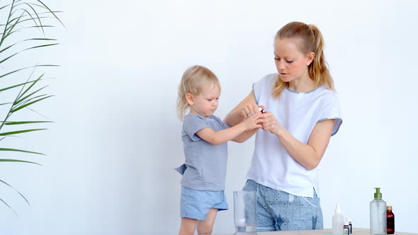 Mom and Son Washing Hands with a Disinfectant To Prevent Infection.