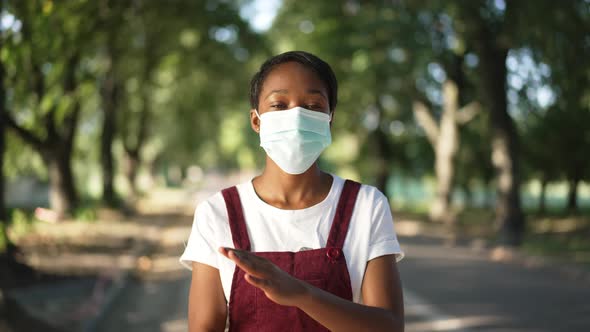 Young Slim African American Woman in Coronavirus Face Mask Gesturing No Crossing Hands in Slow