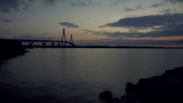 Dramatic timelapse of stunning bridge and magical sunset sky turning into night, cable-stayed tuftfo