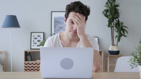 Headache Man Sitting on Casual Chair with Pain in Head