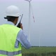 Engineers toolkit come to wind turbine generating electricity in field. - VideoHive Item for Sale