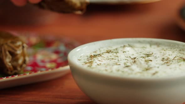 Eating Dolma with Sour Cream Closeup Meat in Grapes Leaves Middle Eastern National Traditional Food