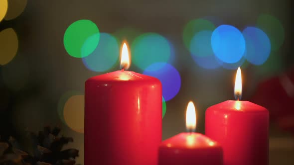 Red Candles Burning, Christmas Lights Twinkling on Background, Miraculous Time