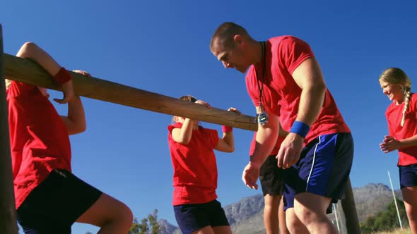 Trainer training kids in the boot camp