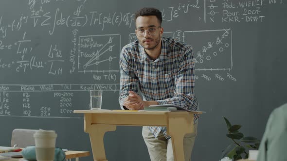 Portrait of University Student at Lectern in Classroom