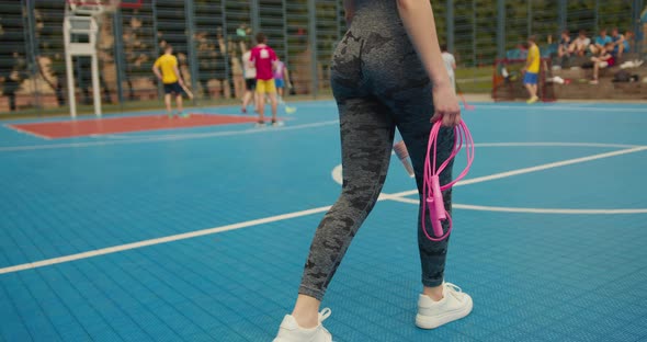 Sport Girl is Walking on the Basketball Court