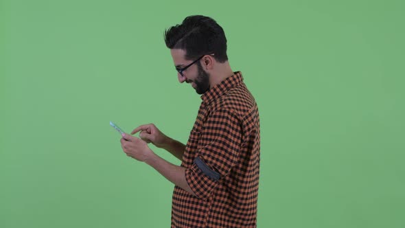 Profile View of Young Bearded Persian Hipster Man with Phone Being Taken Away