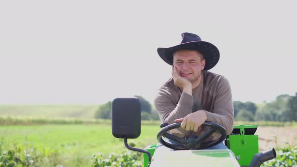 Happy Farmer Near His Green Tractor