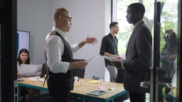 Confident Caucasian CEO Endorsing New African American Employee Talking and Shaking Hands