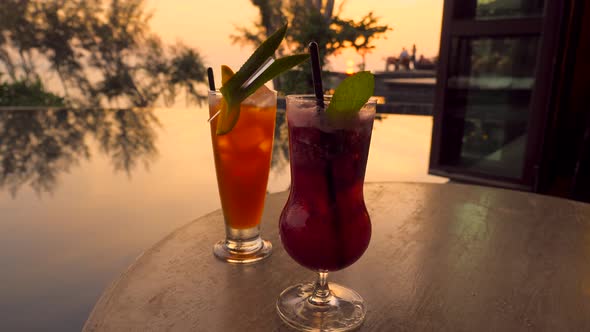 Mocktails for Couple on Table in Outdoor Luxury Restaurant at Tropical Hotel Resort at Sunset