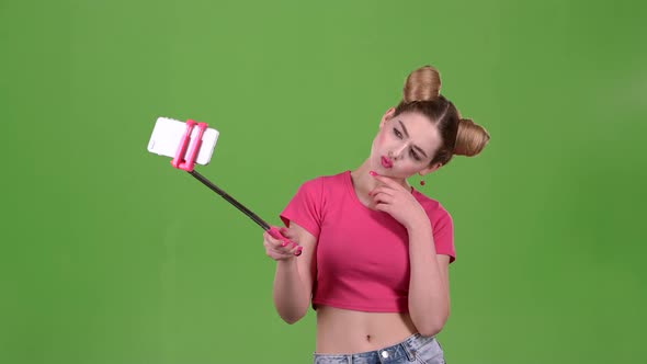 Teen Doing Selfie on Selfie Stick. Green Screen. Slow Motion