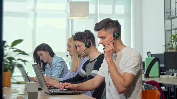 Friendly Young Man Smiling To the Camera, Working at Customer Support Call Center