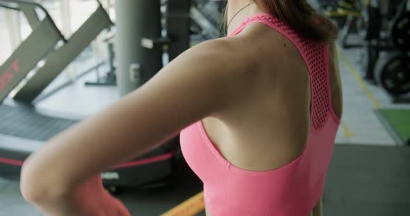 Beautiful Young Woman Does Training with Weighted Bar in Gym. Attractive Female Training